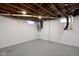 Unfinished basement featuring exposed ceiling, painted concrete walls and glass block windows with room to customize at 6158 Ralston Ave, Indianapolis, IN 46220