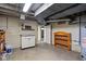 Unfinished basement featuring utility sink, water heater, and shelving providing potential for customization at 6158 Ralston Ave, Indianapolis, IN 46220