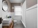 Bathroom featuring wainscoting, a sink, toilet, and shower-tub combo at 6158 Ralston Ave, Indianapolis, IN 46220