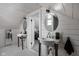 Charming bathroom featuring dual sinks, round mirrors, and wood plank walls at 6158 Ralston Ave, Indianapolis, IN 46220