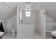 Bright, updated bathroom featuring a stand-up shower, wainscoting, and a pedestal sink at 6158 Ralston Ave, Indianapolis, IN 46220