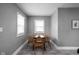 Cozy dining room featuring a round wooden table, four chairs, and natural light from two windows at 6158 Ralston Ave, Indianapolis, IN 46220