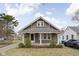 Charming bungalow with a well-maintained front yard and classic architectural details at 6158 Ralston Ave, Indianapolis, IN 46220