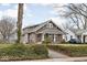 Craftsman home featuring a cozy front porch and mature landscaping at 6158 Ralston Ave, Indianapolis, IN 46220