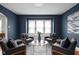 Well-lit living room with four chairs, a glass table, and a large window at 6158 Ralston Ave, Indianapolis, IN 46220