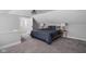 Comfortable main bedroom with gray walls, carpet flooring, and an ensuite bathroom at 6158 Ralston Ave, Indianapolis, IN 46220