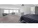 Bright main bedroom with a bed, windows, and access to the ensuite bathroom at 6158 Ralston Ave, Indianapolis, IN 46220