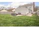 Spacious backyard features lush lawn, patio area, and wood privacy fence at 645 N Ritter Ave, Indianapolis, IN 46219