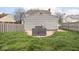 Lush backyard with green lawn, patio area with outdoor seating, and wood privacy fence at 645 N Ritter Ave, Indianapolis, IN 46219