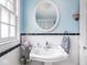 Bright bathroom with classic fixtures, white tile with black trim, and ample counter space at 645 N Ritter Ave, Indianapolis, IN 46219
