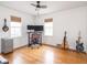 Bright bedroom features hardwood floors, neutral walls, two windows, and ceiling fan at 645 N Ritter Ave, Indianapolis, IN 46219