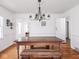 Charming dining room features a farmhouse-style table, hardwood floors, and a modern chandelier at 645 N Ritter Ave, Indianapolis, IN 46219