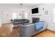 Open living room with hardwood floors, fireplace, and comfortable gray sofas under modern lighting at 645 N Ritter Ave, Indianapolis, IN 46219