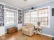 Cozy living room featuring built-in bookshelves, chair, and lots of natural light at 645 N Ritter Ave, Indianapolis, IN 46219