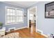 Comfortable light-blue living room featuring wood floors and natural light at 645 N Ritter Ave, Indianapolis, IN 46219