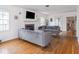 Bright living room featuring hardwood floors, a fireplace, and comfortable gray sofas at 645 N Ritter Ave, Indianapolis, IN 46219