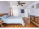 Spacious main bedroom with wood floors, modern wooden furniture, and lots of natural light at 645 N Ritter Ave, Indianapolis, IN 46219
