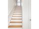 Elegant staircase with wooden steps and white risers, leading to the upper level of the home at 645 N Ritter Ave, Indianapolis, IN 46219
