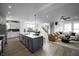 Open-concept kitchen featuring a large island, stainless steel appliances, and hardwood floors at 781 Rose Garden Way, Westfield, IN 46074