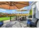 Back deck featuring outdoor seating, dining table, and an umbrella for shade and entertaining at 8107 Parcrest Ct, Indianapolis, IN 46259