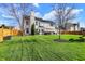 Spacious backyard featuring lush green lawn, patio with outdoor seating, and a privacy fence; great for entertaining at 8107 Parcrest Ct, Indianapolis, IN 46259