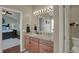 Bathroom vanity featuring double sinks, granite countertops, and updated faucets at 8107 Parcrest Ct, Indianapolis, IN 46259
