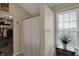 Bathroom featuring a closet with a white curtain, window, and decor hooks on the wall at 8107 Parcrest Ct, Indianapolis, IN 46259