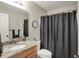 Functional bathroom includes a vanity with a granite countertop, toilet, and shower with a dark curtain at 8107 Parcrest Ct, Indianapolis, IN 46259