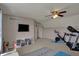 This bonus room has a TV, a storage unit with toys, and gym equipment for fitness activities at 8107 Parcrest Ct, Indianapolis, IN 46259