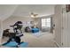 Spacious bonus room features comfortable seating, a ceiling fan, and a treadmill for exercise at 8107 Parcrest Ct, Indianapolis, IN 46259
