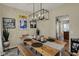Charming dining room featuring a rustic wooden table with bench seating and a modern chandelier at 8107 Parcrest Ct, Indianapolis, IN 46259