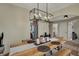 Dining room showcasing a rustic wooden table, bench seating, and an open layout to the kitchen at 8107 Parcrest Ct, Indianapolis, IN 46259