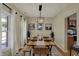 Inviting dining room with a rustic wooden table, bench seating, and modern light fixture at 8107 Parcrest Ct, Indianapolis, IN 46259