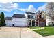 Inviting two-story home with a brick facade, attached two-car garage, and beautiful curb appeal at 8107 Parcrest Ct, Indianapolis, IN 46259