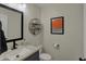 Modern half bathroom featuring updated vanity, mirror, and stylish decor at 8107 Parcrest Ct, Indianapolis, IN 46259