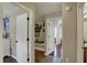 Hallway with hardwood floors and multiple doorways, offering a glimpse into other rooms at 8107 Parcrest Ct, Indianapolis, IN 46259