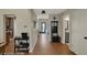 Open hallway with hardwood floors leading to various rooms, enhanced by natural light at 8107 Parcrest Ct, Indianapolis, IN 46259
