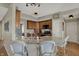 Well-lit kitchen with granite countertops, wooden cabinetry, and breakfast bar seating at 8107 Parcrest Ct, Indianapolis, IN 46259