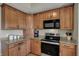 Functional kitchen with wooden cabinetry, granite countertops, and modern appliances at 8107 Parcrest Ct, Indianapolis, IN 46259