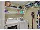 Laundry room featuring a washer, dryer, and shelving for storage and cleaning supplies at 8107 Parcrest Ct, Indianapolis, IN 46259