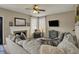 Inviting living room with a fireplace, large sofa, and plenty of natural light at 8107 Parcrest Ct, Indianapolis, IN 46259