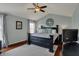 Spacious main bedroom with tray ceiling, a king-size bed, and a large window for natural light at 8107 Parcrest Ct, Indianapolis, IN 46259