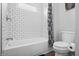 Bathroom featuring tiled shower and bathtub, plus modern toilet at 8414 Anchorage Ct, Indianapolis, IN 46236