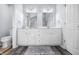 Bathroom featuring double sinks, ample counter space, and wood-look flooring at 8414 Anchorage Ct, Indianapolis, IN 46236