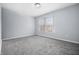 Carpeted bedroom with neutral walls and window providing natural light at 8414 Anchorage Ct, Indianapolis, IN 46236
