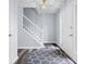 Inviting foyer featuring a staircase, hardwood floors, and a stylish rug at 8414 Anchorage Ct, Indianapolis, IN 46236