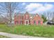 Charming two-story brick home with red shutters and a well-manicured lawn at 8414 Anchorage Ct, Indianapolis, IN 46236