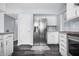 Updated kitchen features stainless steel refrigerator and white cabinetry at 8414 Anchorage Ct, Indianapolis, IN 46236