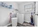 Laundry room with a washing machine, shelving, and natural light from the window at 8414 Anchorage Ct, Indianapolis, IN 46236