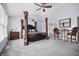 Spacious primary bedroom showcasing a four-poster bed and a ceiling fan at 8414 Anchorage Ct, Indianapolis, IN 46236